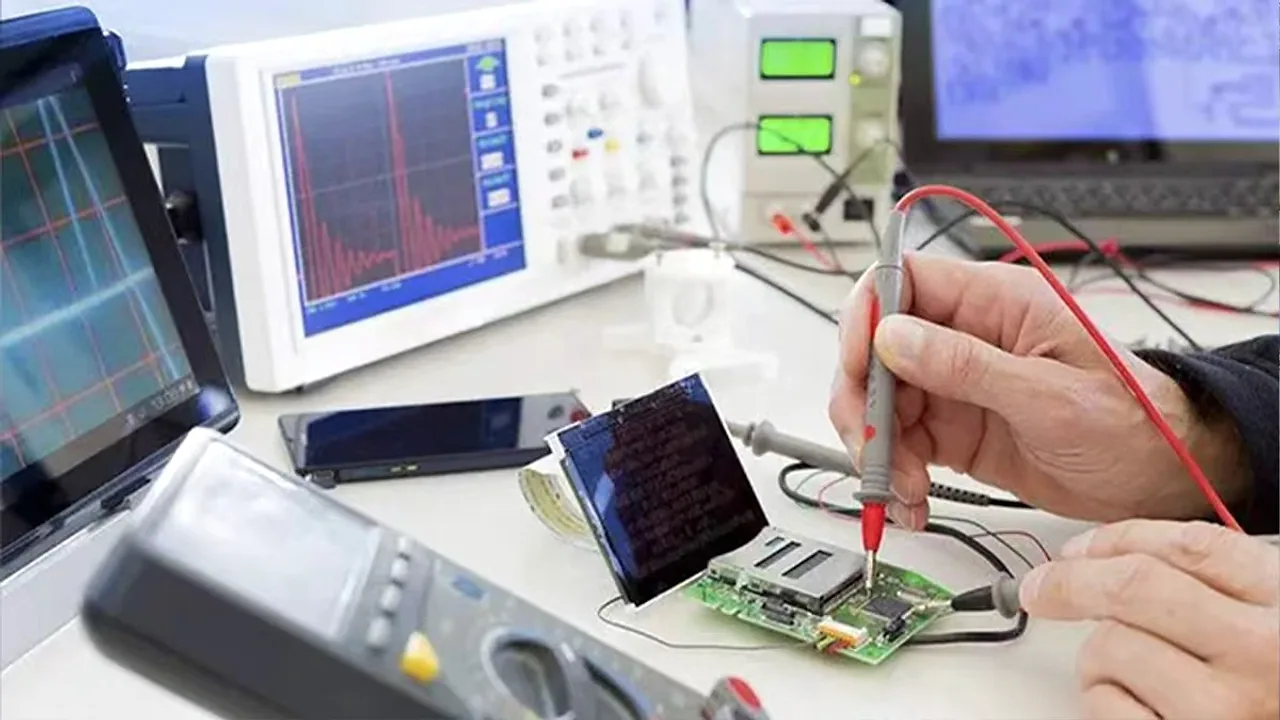 TOPTAI engineer testing a power bank circuit board with electronic measurement equipment